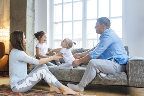 Family playing on sofa