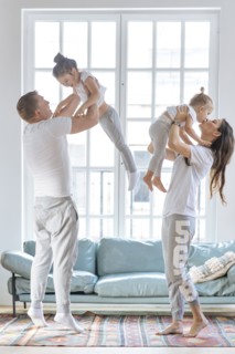 Parent lifting daughters by window