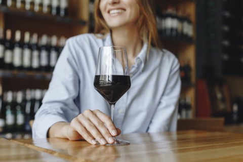 Woman holding glass of red wine