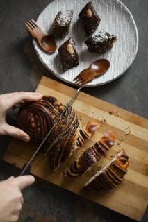 Woman cutting pastry by brownies