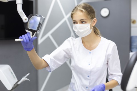 Dental assistant holding light