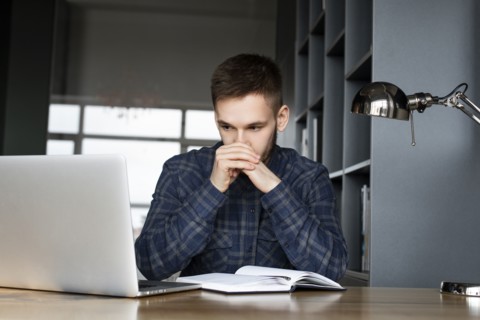 Young businessman looking at laptop