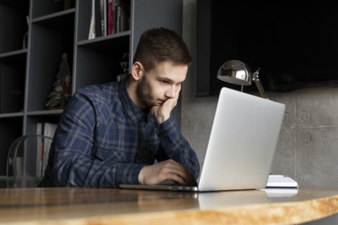 Young businessman looking at laptop