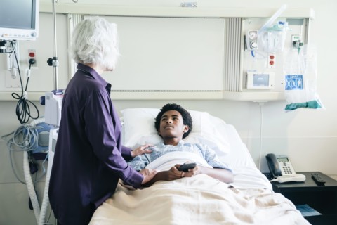 Doctor comforting teenage patient