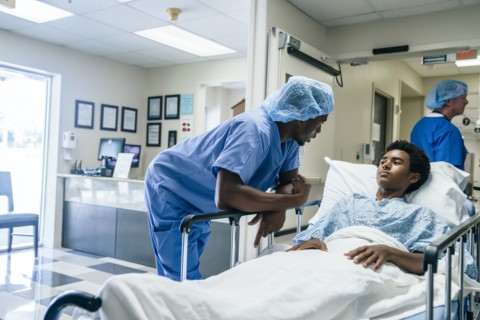 Nurse talking to teenage patient