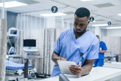 Nurse using digital tablet in hospital