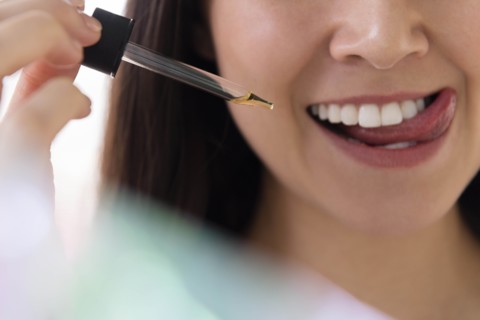 Woman with pipette of essential oil