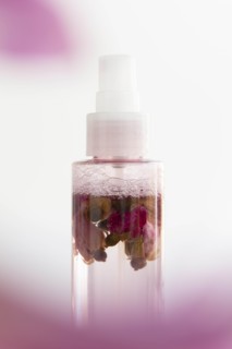 Skin care spray bottle with flowers inside