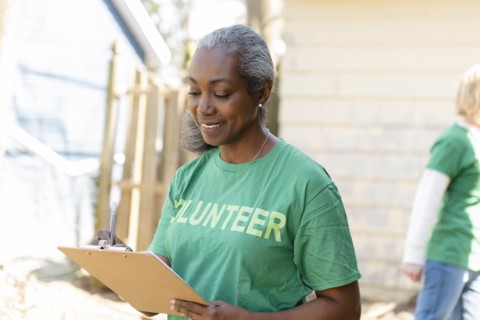 Mature woman volunteer with clipboard
