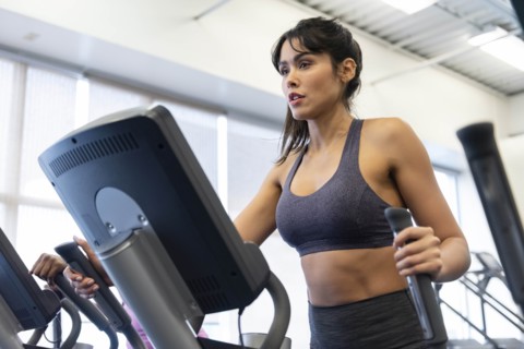 Woman exercising on elliptical machine