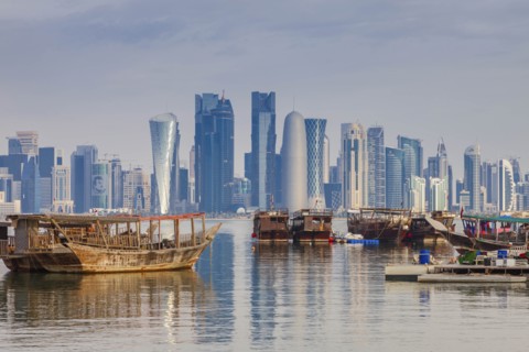 Boats by skyscraper skyline in Doha, Qatar