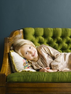 Girl  lying on green sofa