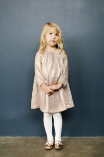 Girl wearing taupe dress