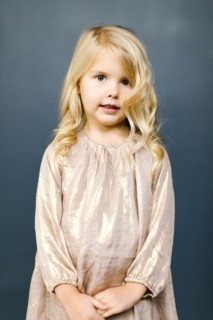 Girl wearing taupe dress