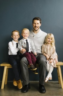 Father sitting with his three children
