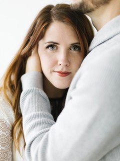 Mid adult woman in man's embrace