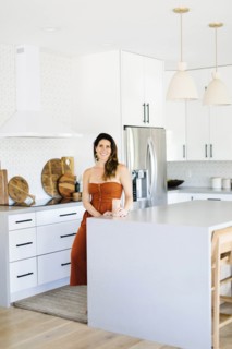 Mid adult woman smiling in kitchen
