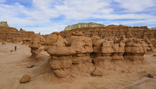 Woman hiking through Goblin Valley State Park in Utah, USA