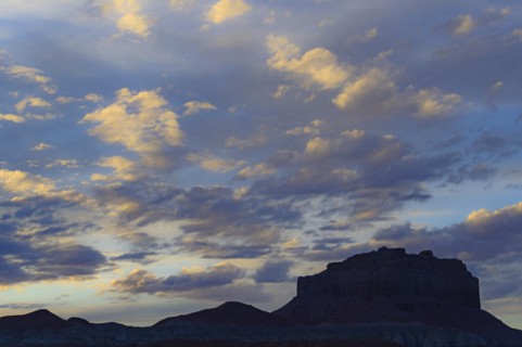 Silhouette of rock formations under clouds at sunset in Goblin Valley State Park, Utah, USA