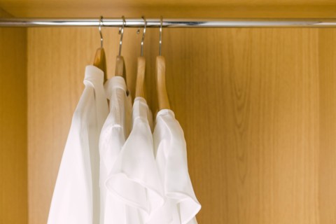 Shirts on clothes hangers in wardrobe