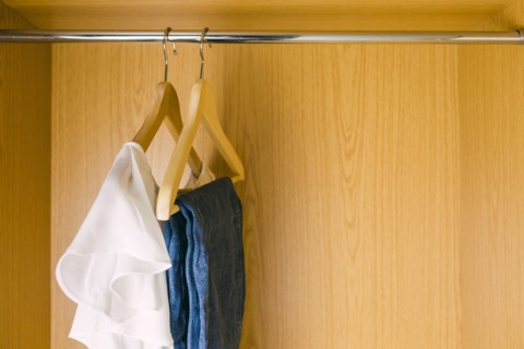 Clothes hanging in wardrobe