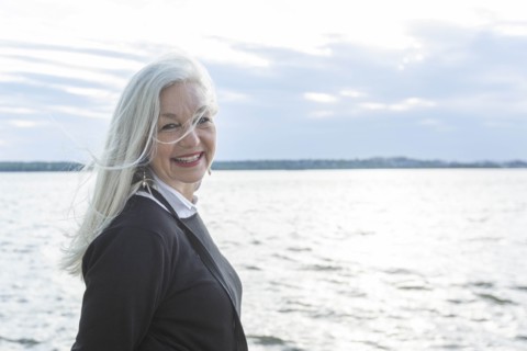 Smiling mature woman by Potomac River in Washington DC, USA