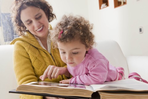 Mother and daughter reading picture book