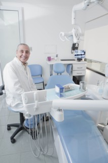 Dentist smiling in dentist's surgery