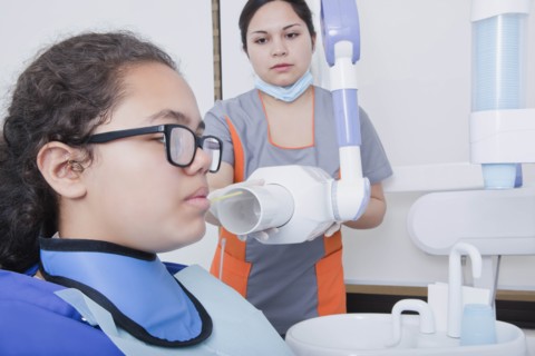 Patient getting X-ray at dentist's surgery