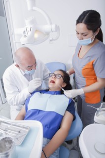 Teenage girl getting dental cleaning