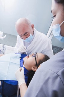 Teenage girl getting dental cleaning