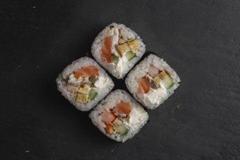 Salmon sushi on black surface