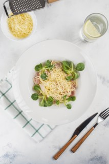Pasta topped with cheese and basil