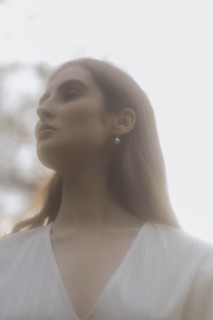 Brown haired young woman looking away