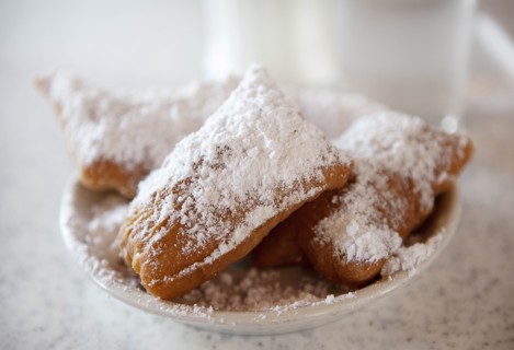 Beignets with powdered sugar on plate