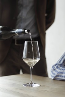 Man pouring bottle of wine