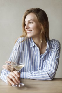 Young woman with glass of white wine