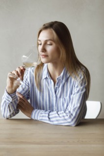 Young woman with glass of white wine