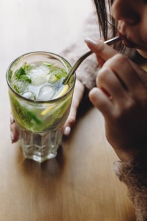 Young woman drinking cocktail
