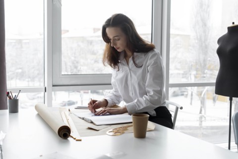 Fashion designer working at desk in studio