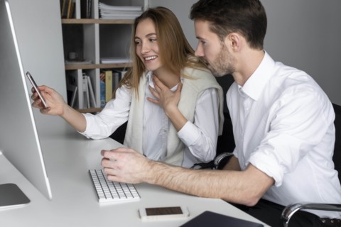 Businesspeople using computer together