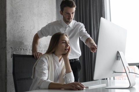 Businesspeople using computer together