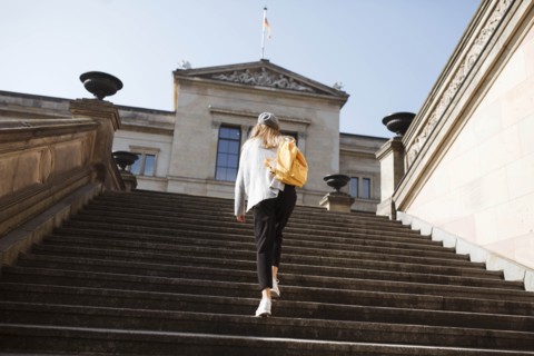 Young woman walking on steps in Berlin, Germany