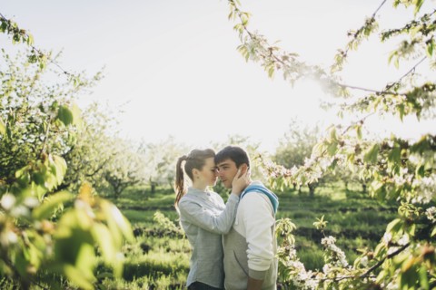 Young couple embracing by trees