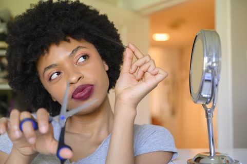 Young woman contemplating cutting her hair
