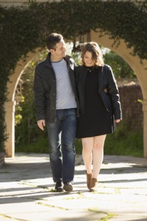 Young couple walking by arch