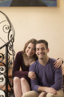 Smiling young couple sitting on staircase