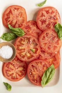 Sliced tomatoes with basil and salt