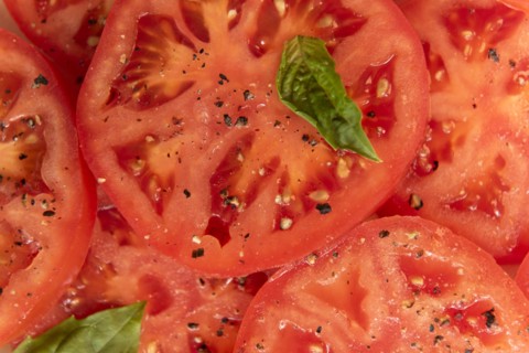 Sliced tomatoes with basil and pepper