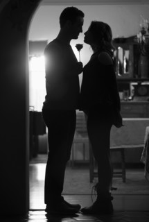 Silhouettes of couple with rose in doorway